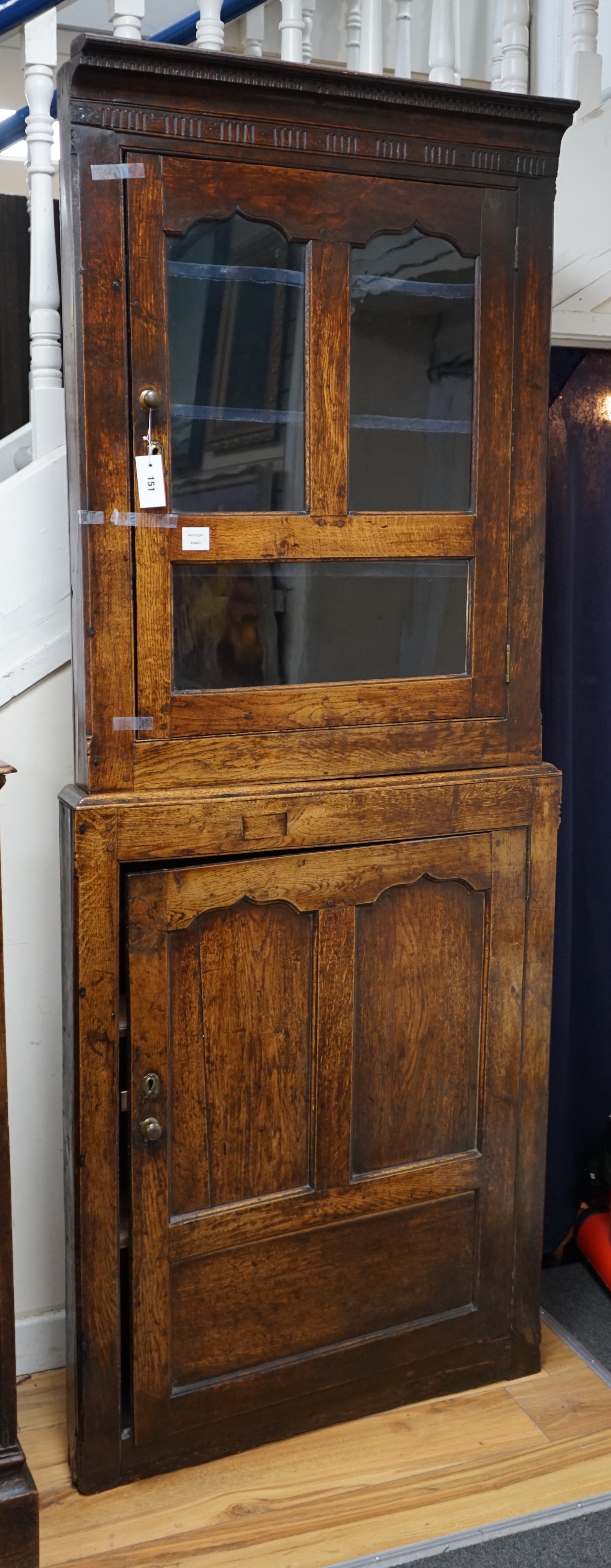 An 18th century two-sectional Provincial oak standing corner cupboard, width 80cm depth 30cm height 206cm